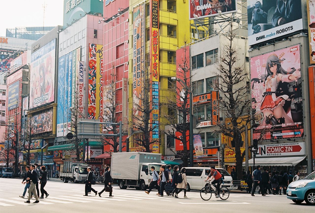 about-03 Busy Akihabara street in Tokyo with colorful billboards and pedestrians.